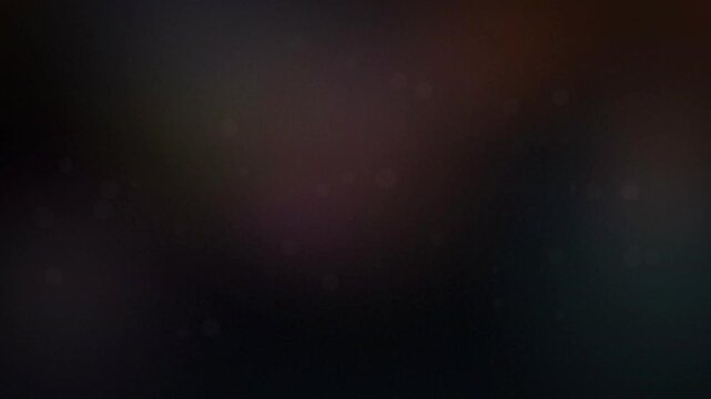 Abstract glowing particles and soft bokeh lights on a dark background, ideal for motion graphics, digital overlays and cinematic video backgrounds