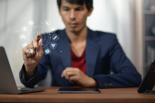 Modern professional man using futuristic technology interface at work station