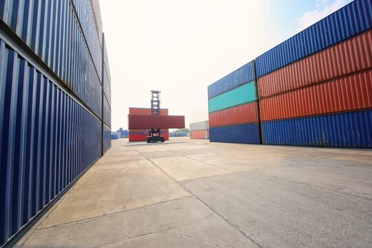 Rows of stacked colorful cargo shipping containers at terminal with container shipping terminal logistics