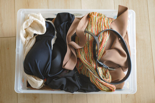 Clothing and accessories in a plastic storage box