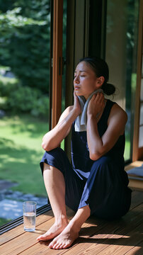 Athletic Asian Woman Strength Training with Dumbbells in Modern Gym