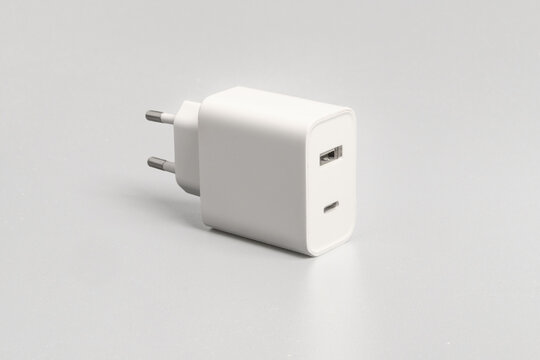 White Dual Port USB and Type-C Fast Charger Adapter Isolated on Light Grey Background