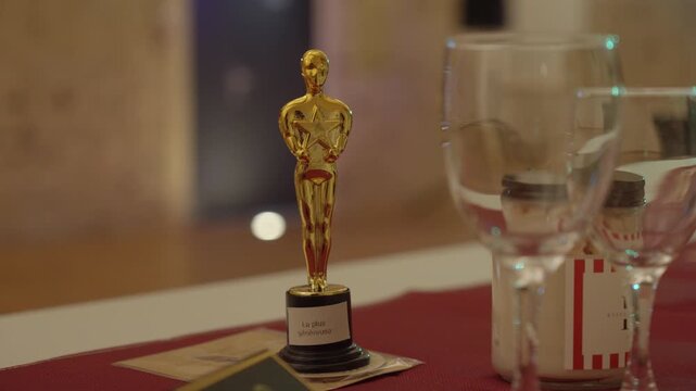 Close-up View of Golden Oscar Statuette Table Decoration for Cinema Themed Event