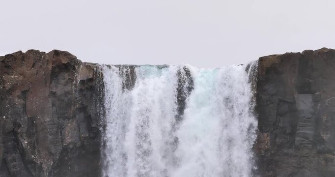 Aerial drone view of the upper cascades of Godafoss Waterfall on the Skjalfandafljot River in North Iceland featuring powerful flowing water and basalt cliffs
