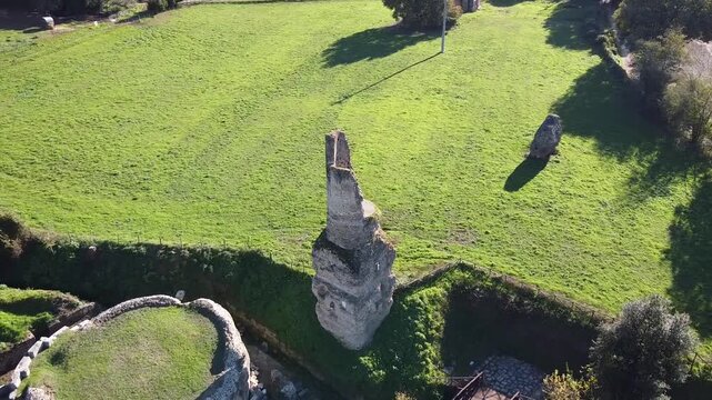 Aerial drone view of the Roman aqueduct ruins at Parco degli Acquedotti in Rome Italy featuring ancient stone remains green parkland and archaeological landscape
