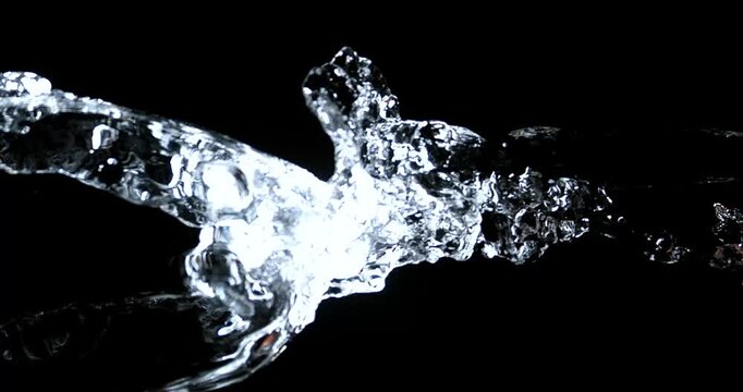Crystal clear water droplets splash dramatically against a dark background.