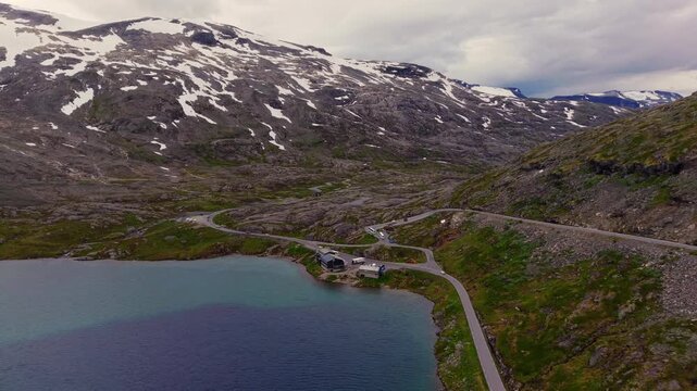 drone reveals of the Lake Djupvatnet and its surrounding rocky peaks in Norway with panoramic road M&oslash;re Romsdal county