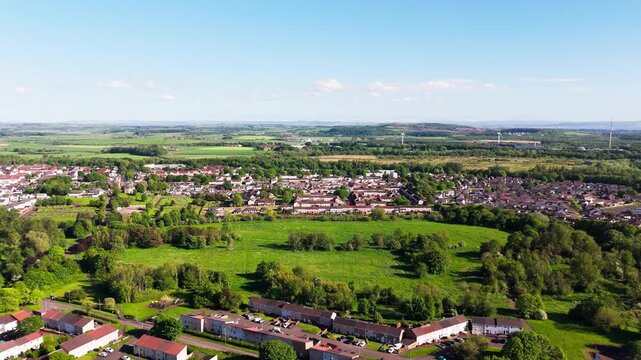 Bourtreehill Village, Irvine, North Ayrshire, Scotland, showcasing residential neighbourhoods surrounded by woodland, parkland and open countryside, aerial dolly forward view