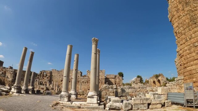 Temple of Castor and Pollux ruins in Roman Forum Rome Italy showing ancient columns stone remains brick structures and archaeological details under blue sky