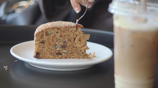 Enjoying cake and drink at a cafe table