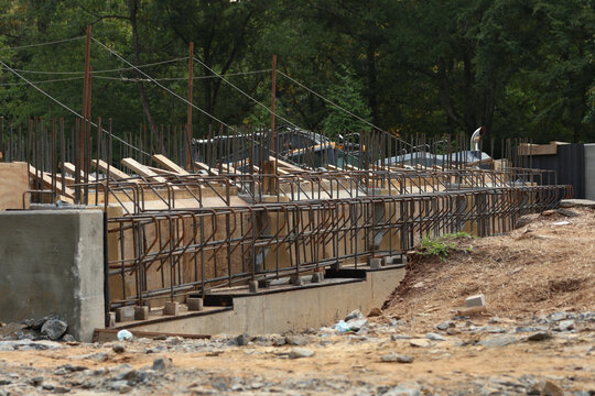Bridge construction. A construction site featuring reinforced concrete beams and a steel rebar framework during the erection of the bridge structure.