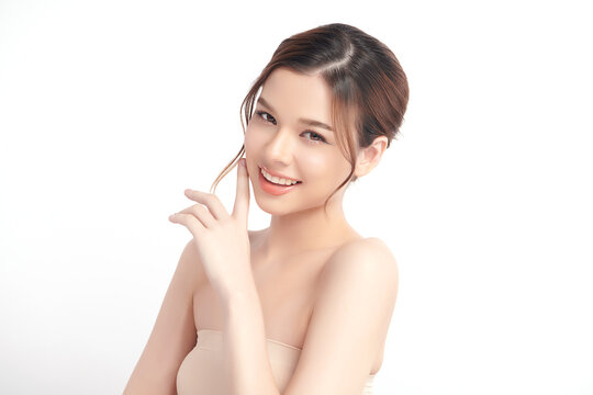 A beautiful young Asian woman with clean, fresh skin against a white background. Skincare, facial treatment, cosmetology, beauty, and spa. An elegant portrait of an Asian woman.