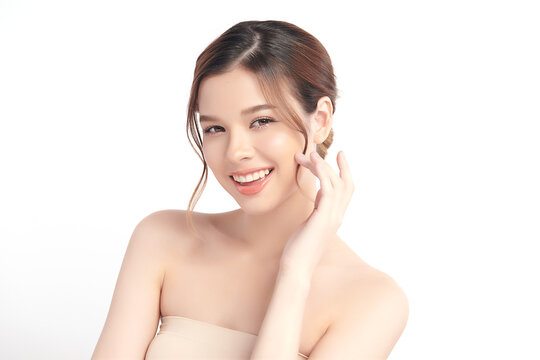 A beautiful young Asian woman with clean, fresh skin against a white background. Skincare, facial treatment, cosmetology, beauty, and spa. An elegant portrait of an Asian woman.