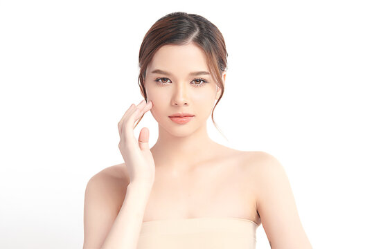 A beautiful young Asian woman with clean, fresh skin against a white background. Skincare, facial treatment, cosmetology, beauty, and spa. An elegant portrait of an Asian woman.