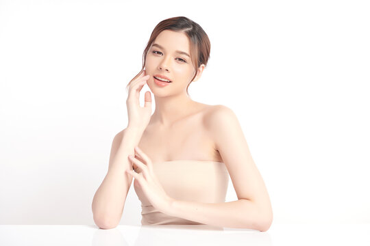 A beautiful young Asian woman with clean, fresh skin against a white background. Skincare, facial treatment, cosmetology, beauty, and spa. An elegant portrait of an Asian woman.
