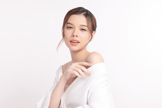 A beautiful young Asian woman with clean, fresh skin against a white background. Skincare, facial treatment, cosmetology, beauty, and spa. An elegant portrait of an Asian woman.