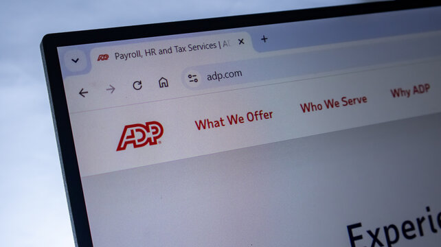 ADP payroll and HR services website homepage displayed on a modern laptop screen.