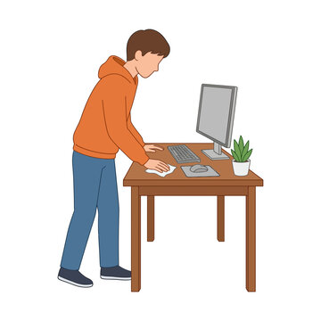Young Man Cleaning His Home Office Desk with a Cloth for a Tidy and Productive Workspace