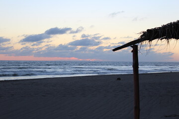 Soft twilight paints the sky above the ocean's edge © Erick