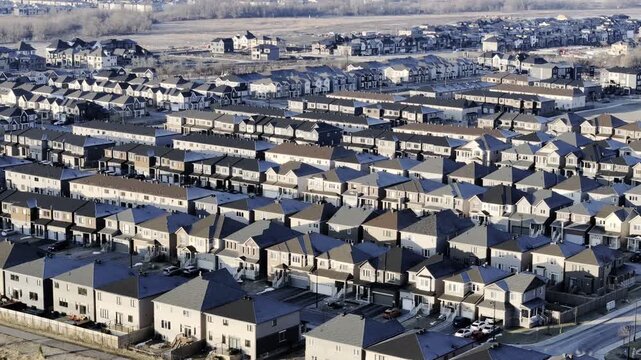 Aerial view of Barrhaven suburban housing development in Ottawa during early winter morning light. g.