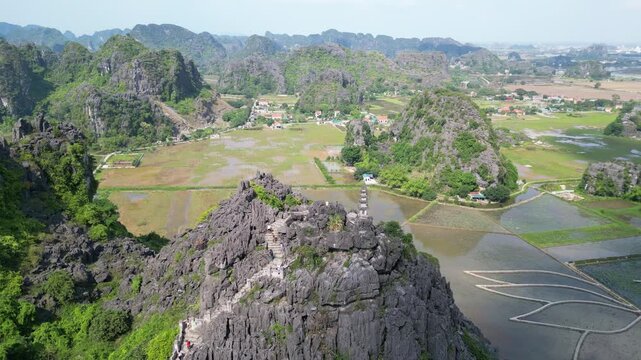 Aerial view of vietnamese pagoda on top of karst hill in Ninh Binh, Vietnam.