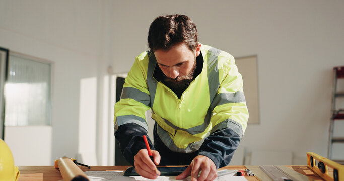 Engineer, drawing and project with man and blueprint for property surveyor, architect or renovation. Drafting, floor plan or building contractor with person on construction site for remodeling