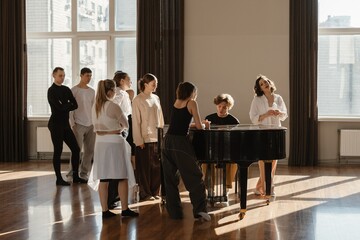 Fototapeta premium Group of dancers playing piano in a contemporary dance studio