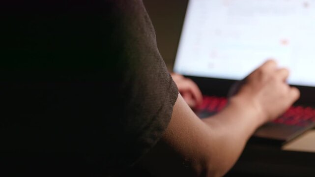 Close‑up of human hands typing on mechanical keyboard, office workspace background, computer work footage