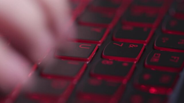 Close‑up of human hands typing on mechanical keyboard, office workspace background, computer work footage