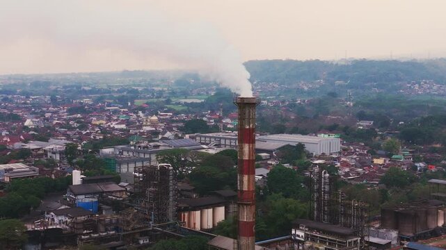 Aerial drone view of an industrial fuel storage terminal in Indonesia, featuring large storage tanks, pipelines, loading facilities, and supporting infrastructure for petroleum products and energy dis