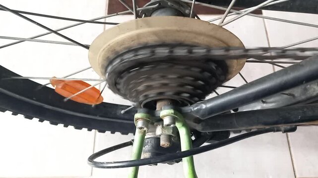 Close up of bicycle rear sprockets and chain links meshing perfectly during a pedaling action