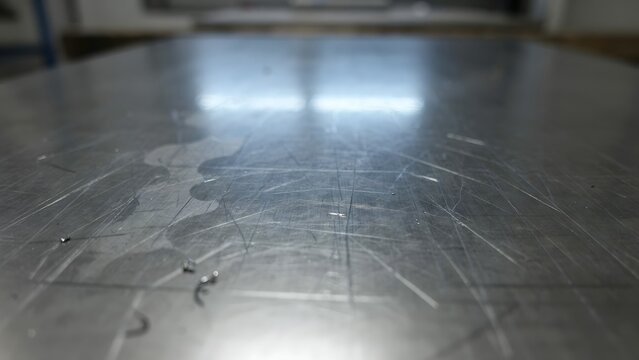Polished Metal Surface with Reflective Texture and Scratches