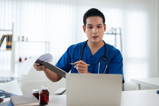 Doctor looking at laptop screen writing in notebook for research planning or medical tech innovation in hospital office. Healthcare medic worker, research strategy book notes and online communication.