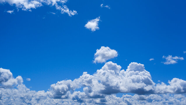 White clumps of clouds in the summer blue sky, clean and fluffy, are perfect for the background.