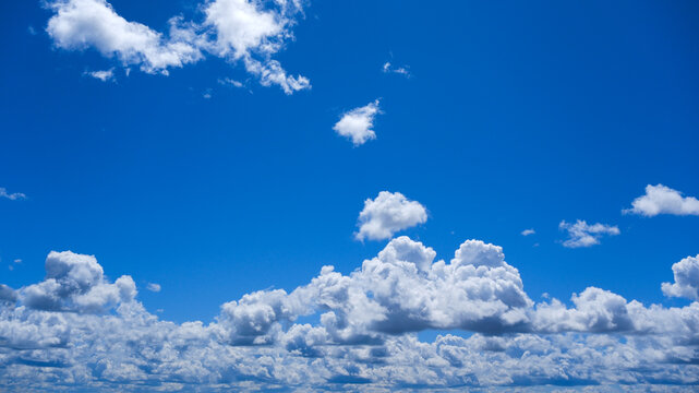 White clumps of clouds in the summer blue sky, clean and fluffy, are perfect for the background.