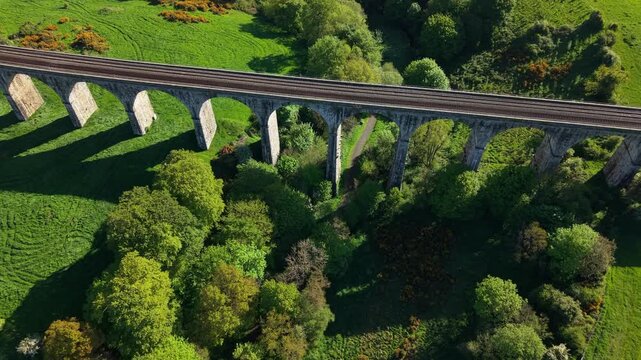 Elongated historic arch Craigmore Viaduct onroute Dublin Belfast drone shot