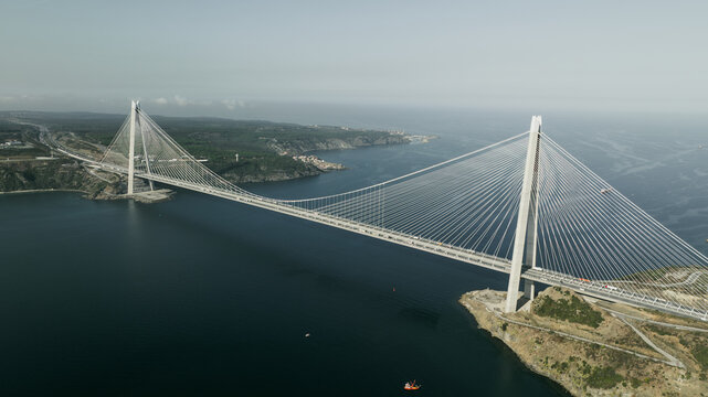 Aerial view of the Yavuz Sultan Selim Bridge spanning the Bosphorus strait with suspension cables, concrete towers, and surrounding coastal landscape in Beykoz, Istanbul, Turkey.