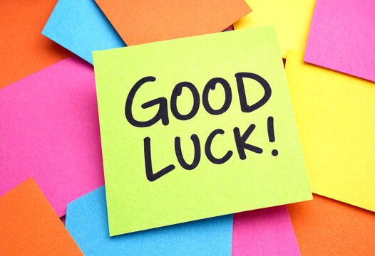 Bright colorful sticky note with good luck message written in bold letters on top