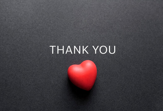 Heartfelt thank you message with a small red heart shape on dark background perfect for gratitude cards
