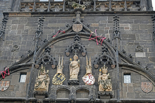 Gothic facade detail with statues on a historic tower near Charles Bridge, Prague, Statue of a saint with a golden star halo in a wall niche near Charles Bridge, Prague, Czech RepublicCzech Republic