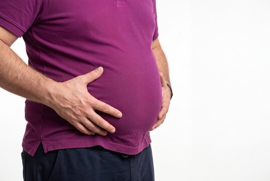 Closeup of a man with a large belly holding his stomach isolated on white background