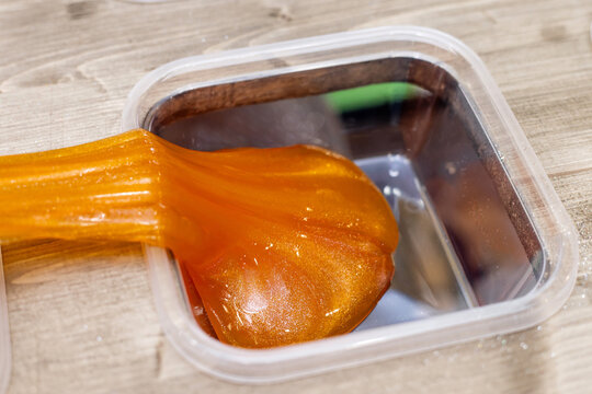 Close-Up of Elastic Glittering Therapeutic Putty Substance Demonstrating Viscosity and Sensory Play Development for Kids