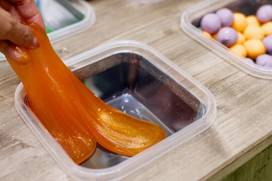 Close-Up of Elastic Glittering Therapeutic Putty Substance Demonstrating Viscosity and Sensory Play Development for Kids