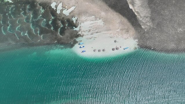 Aerial view of Banco de arenas Grand Grossier featuring turquoise waters, small boats, and umbrellas on the sandbank in Monte Cristi, Monte Cristi, Dominican Republic.