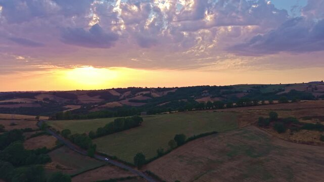 Aerial Sunset Over Patchwork Farmland and Rolling Countryside