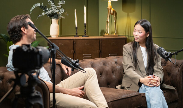 Man and woman having a discussion, creating audio content for a broadcast