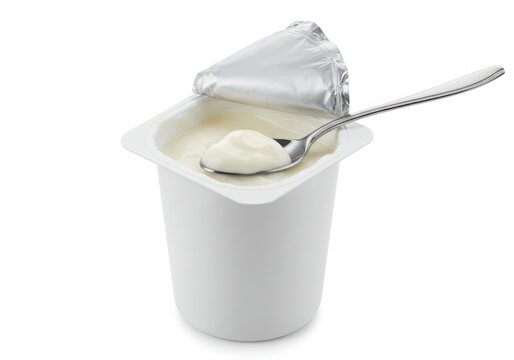 Open yogurt cup with spoon isolated on white background