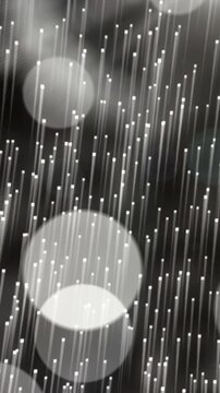 Animation of white shooting stars and bokeh light spots moving on black background