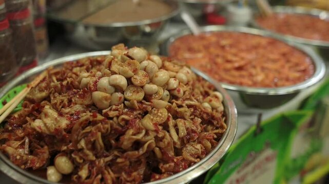 Vietnamese Street Market Bowl Of Dried Shrimp And Quail Eggs, Metal Tray Piled With Crispy Fried Shallots And Quail Eggs, Green Chopsticks, Spice Jars And Saucy Condiment In Background, Warm