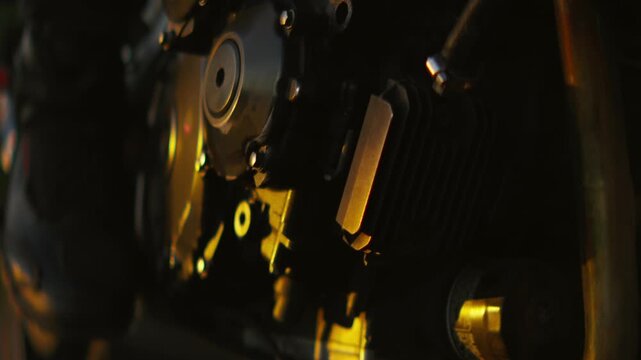Motorcycle rider at sunset with reflective helmet visor and close-up engine details capturing cinematic light, motion, and mechanical adventure atmosphere